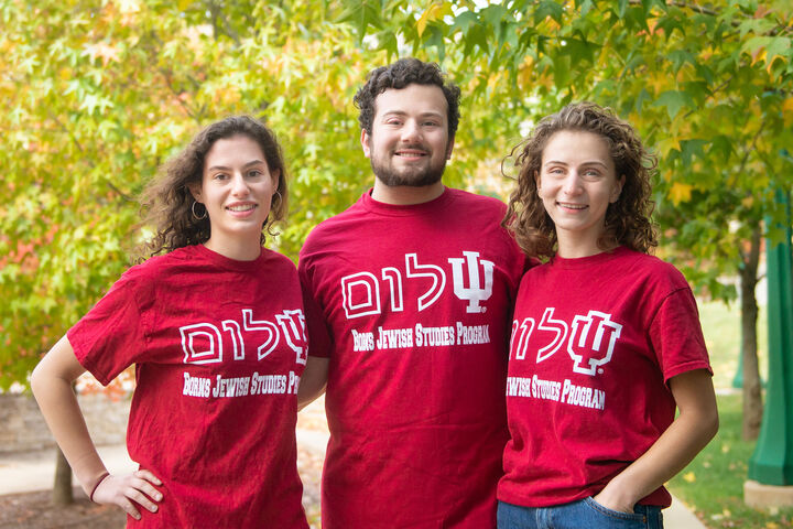 Three students smiling and wearing matching IU Borns Jewish Studies Program tee shirts.